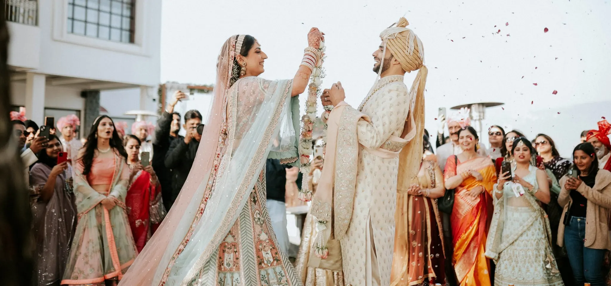 Indian wedding couple celebrating with family and friends